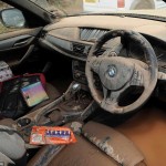 © Peter Summers / Newsteam 24/07/2013 Wrecked car: This BMW is covered in dirt and the footwell submerged in water as flash floods hit in Southwell, Nottinghamshire