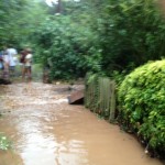 The (blurry) crowd scene shows folks from Westhorpe unable to get to our house over the dyke. This was effectively a watery crossroads where the water was flooding down our drive from the direction of Westhorpe Hall and then met the dyke flowing in the other direction.