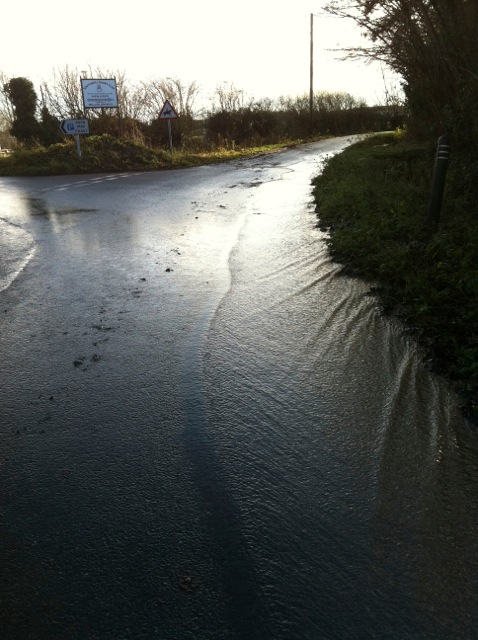 Surface water at junction with road from car park off Park Lane